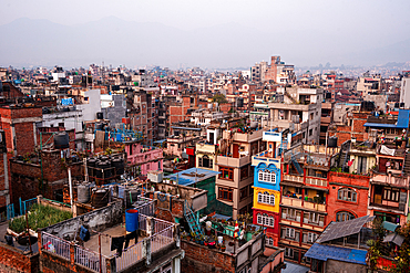 Aerial view over tightly packed rooftops and colorful residential buildings in Kathmandu, Nepal