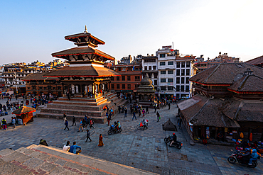 Elevated view of Durbar Square in Kathmandu with Nyatapola-style pagoda temple and surrounding urban life during golden hour