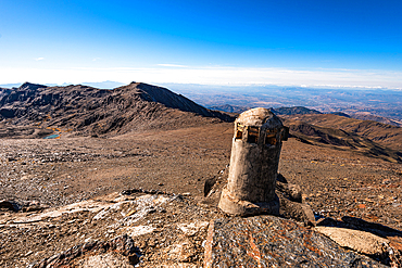 Remains of a crumbling military watchtower in the high Sierra Nevada, Andalusia, Spain. Historic architecture against the barren alpine landscape.