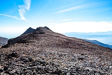 rugged summit ridge of Pico del Caballo under a clear sky in the Sierra Nevada mountains, Andalusia, Spain.
