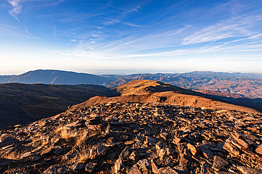Wide summit ridge with panoramic mountain views from Pico del Caballo , Sierra Nevada, Andalusia, Spain.