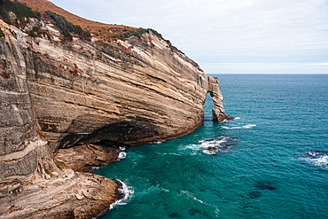 Eroded cliffs and rugged coastlines define the dramatic scenery of Cape Farewell, the northernmost point of South Island, New Zealand.
