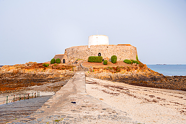 The Napoleonic-era Fort Grey Martello tower, known as the Cup and Saucer, standing on a tidal islet in Rocquaine Bay, Guernsey, Channel Islands, United Kingdom.