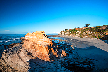 Unique coastal rock formations and cliffs along the Tasman Sea near Westport, South Island, New Zealand.