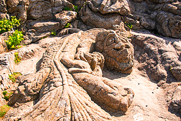 : A detailed view of one of the famous granite carvings of Les Rochers Sculptés in Rothéneuf, near Saint-Malo, Brittany, France. The rock sculpture, created by Abbé Adolphe-Julien Fouéré in the late 19th century