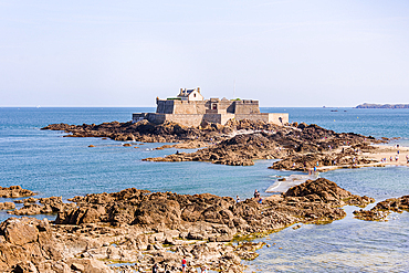 Fort National on a rocky islet off the coast of Saint-Malo, Brittany, France, surrounded by the blue waters of the Atlantic Ocean