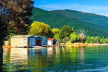 Picturesque floating boathouses line the calm waters of Marlborough Sounds near Picton, South Island, New Zealand.