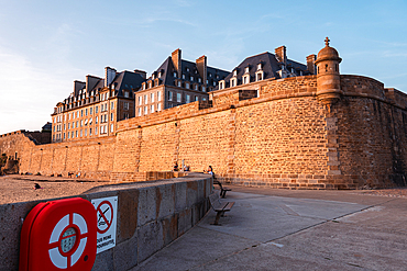 Historic stone ramparts and old town walls Saint Malo Brittany France evening light on fortified seafront