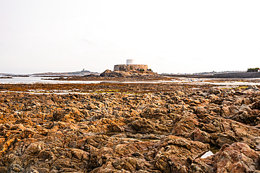 Fort Grey Martello tower on rocky tidal shore in Guernsey Channel Islands historic landmark