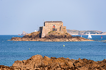 Fort National fortress seen across rocky coastline and blue sea at Saint-Malo Brittany France