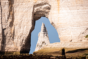 The famous Étretat cliffs in Normandy, France, with a natural arch framing the sharp sea stack known as L’Aiguille.