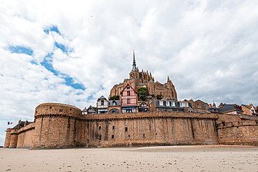 Historic stone ramparts and medieval houses of Mont Saint-Michel, Normandy, France.