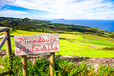 Wooden sign marking Miradouro da Moita Alta, a scenic viewpoint overlooking the Atlantic and Corvo Island from Flores Island, Azores, Portugal.