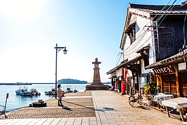 Iconic stone lighthouse at the port of the traditional fishing village, Tomonoura, Honshu, Japan, Asia