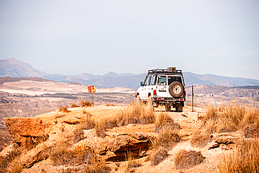 4x4 parked on the edge of a cliff in the Desierto de Gorafe, Granada, Spain