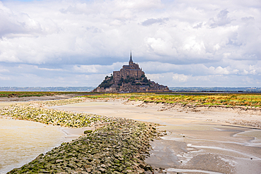 Mont Saint-Michel seen across sandy tidal channels at low tide, Normandy, France