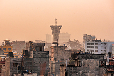 Orange sunrise view over the roof tops in Thamel showing Skywalk Tower Kamaladi, Kathmandu, Nepal, Asia