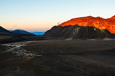 Red sunrise on Mount Tongariro with volcanic plain in front, Tongariro National Park, UNESCO World Heritage Site, North Island, New Zealand, Pacific