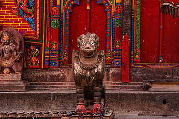 The guardian Bird statue in front of red wall at Hindu Temple of Changu Narayan, UNESCO World Heritage Site, Changunarayan, Kathmandu Valley, Nepal, Asia