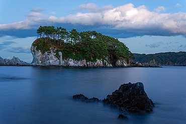 Long exposure of seascape with white cliff island with trees in distance, Jodogahama, Iwate prefecture, Japan, Asia