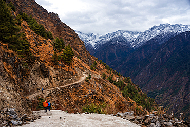 Beginning of the Langtang valley trek with hikers following the road towards snowy mountains of the Himalayas, Nepal, Asia