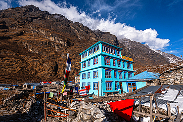 Turquoise mountain lodge in front of high mountains and view over Lang Tang village, Himalayas, Nepal, Asia