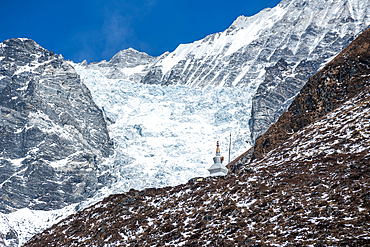 Close up of stupa (chorten) on a mountain slope in front of glaciers, Kyanjin Gompa, Langtang Valley trek, Himalayas, Nepal, Asia