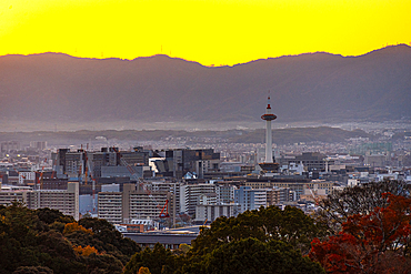 Kyoto skyline at sunset with a vibrant orange sky, Kyoto Tower, Kyoto, Honshu, Japan, Asia