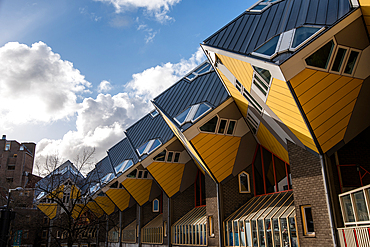 Cube Houses, vibrant yellow unique cube architecture with a blue sky, Rotterdam, The Netherlands, Europe