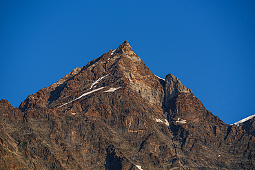 Close up of the rugged summit of Dufoursppitze, Monte Rosa against a blue sky. Nature Park Valsesia and the Alta Val Strona