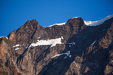 Close up of the rugged summit of Signalkuppe, Monte Rosa against a blue sky. Nature Park Valsesia and the Alta Val Strona