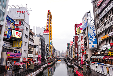 View along the channels, walking paths and bridges along Dotonbori River on an overcast day, Osaka, Honshu, Japan, Asia