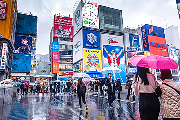 Famous Dotonbori Glico Sign. Large vibrant advertisment on a rainy day. Dotonbori, Osaka, Japan