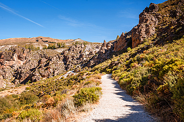 Hiking trail in the arid gorge canyon landscape of Los Cahorros Monachil, Monachil, Sierra Nevada, Granada, Andalusia, Spain, Europe