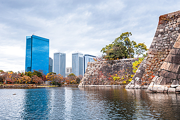 Osaka Castle walls and moat with The Crystal Tower, Osaka Business Park beyond, Osaka, Honshu, Japan, Asia