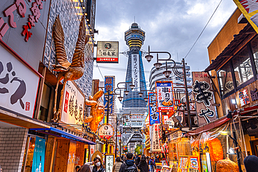 Shinsekai District and Tsutenkaku Tower in the evening with colorful neon lights of restaurants, Osaka, Honshu, Japan, Asia