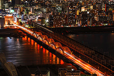 Traffic on bridges crossing the Yodo River and midnight night skyline of Osaka, Honshu, Japan, Asia