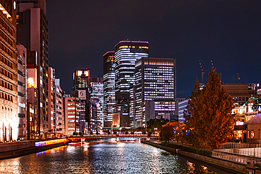 Nighttime cityscape of Osaka, Japan. Skyscrapers at Tosahori River. Lights of the Skyscrapers of Conrad Osaka