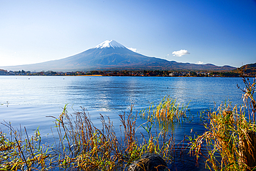 Mount Fuji yama ice capped volcano with a clear blue lake in front. Autumnal Japan, volcano