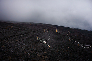 Hiking path in the ashes of mount Fuji in a fog cloud, Japan Volcano