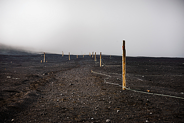 Hiking path in the ashes of mount Fuji in a fog cloud, Japan Volcano