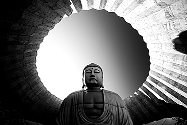 Black and white image of a Buddha statue framed in circular architecture, Hill of the Buddha, Sapporo, Hokkaido, Japan, Asia