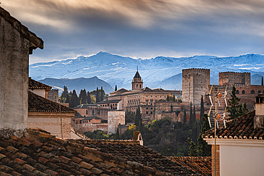 albaycin roof tops, Alhambra and snowy mountains in Granada, Spain. First snow in Autumn in the Sierra Nevada behind Alhambra, Granada