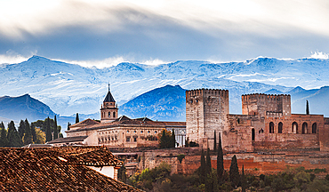 Snowy Sierra Nevada in early winter with Pico de Veleta behind the warm colored Alhambra, UNESCO World Heritage Site, Granada, Andalusia, Spain, Europe