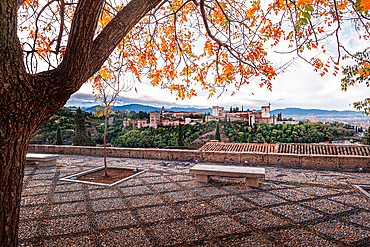 Autumn n Granada Spain. Mirador San Nicolas with orange foliage in front of Alhambra