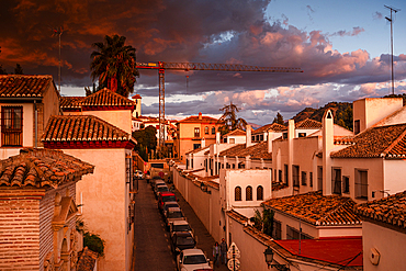 Dramatic warm sunset over the main alley of Albaicin, Granada, Spain. Calle Santa Isabe la Real.