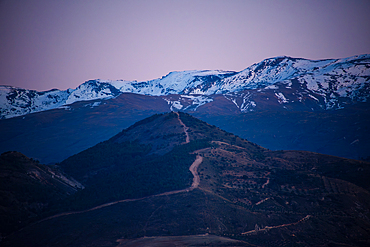 Purple soft light in the evening above the snowy peaks of Sierra Nevada, Spain.