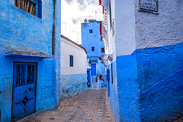 Sunrise over blue-painted houses and streets in Chefchaouen, Morocco, highlighting the city's charm.