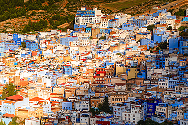 Sunrise over the skyline of the Chefchaouen Medina, Morocco. Close up of a warm light cast over blue houses in the Valley