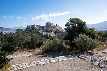 View of the Acropolis of Athens from Mouseion Hill, located to the southwest. The Acropolis, an ancient citadel perched on a rocky outcrop above the city, contains the remains of several significant ancient buildings, including the Parthenon.